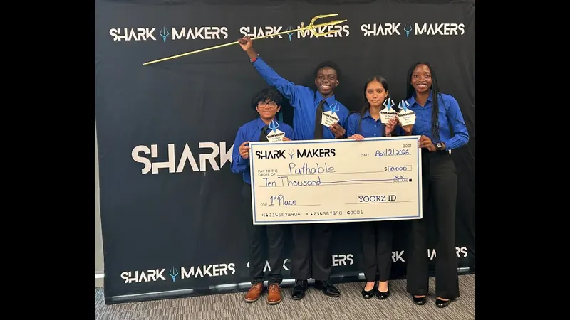 The four students of Pathable holding their first-place check.